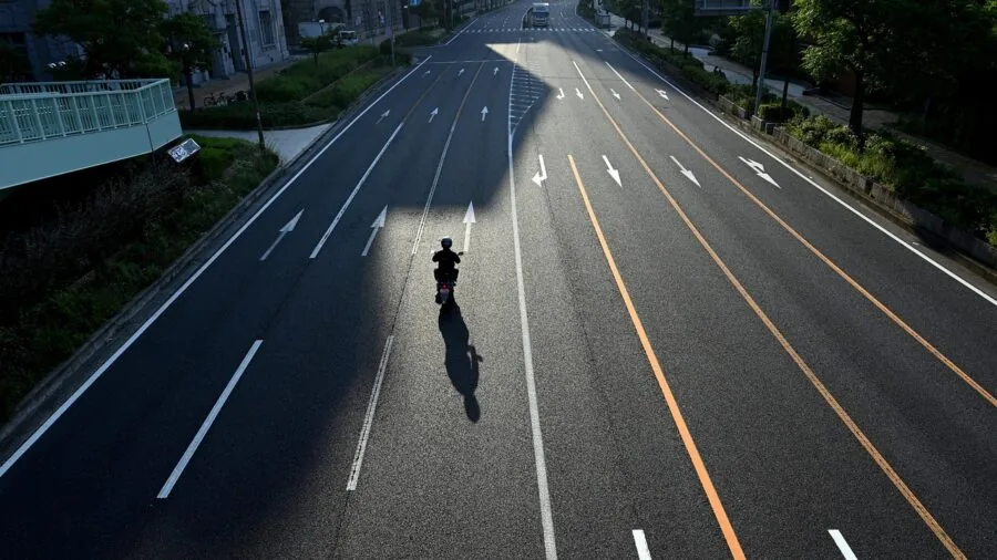 Motorcyclist riding on open highway with wind and motion blur, illustrating audio challenges of motorcycle travel