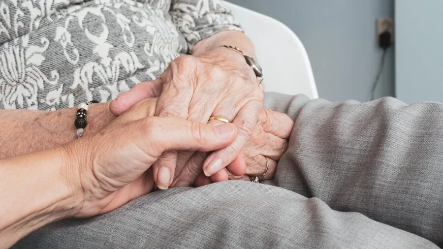 Older adult wearing a comfortable smartwatch during daily activities, showing proper fit and wearability