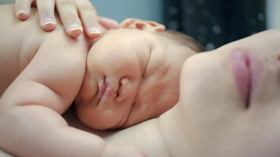 Parent monitoring baby health data on smartphone from bedroom, modern parenting technology and sleep tracking
