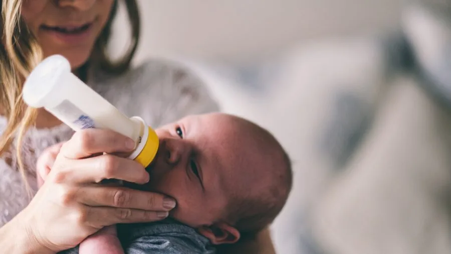 Parent monitoring baby on smartphone device in home setting