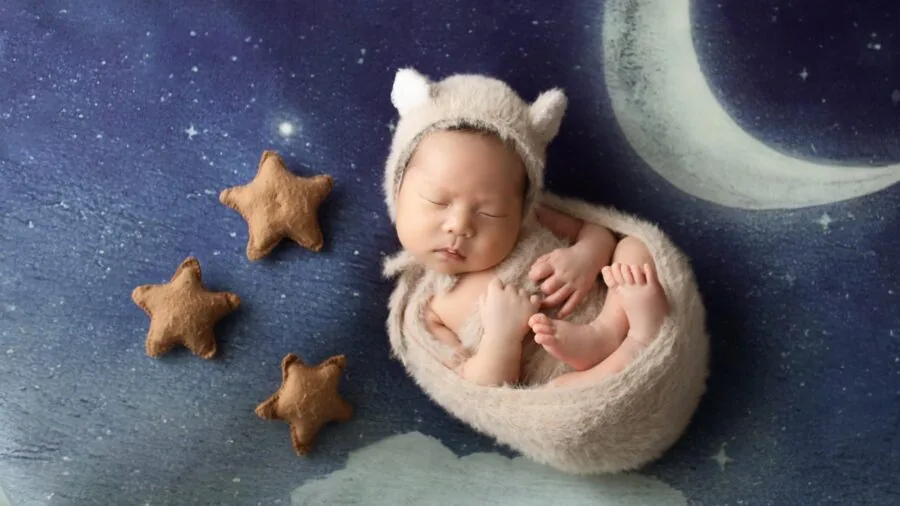 Parent monitoring infant sleeping in crib during nighttime with gentle lighting
