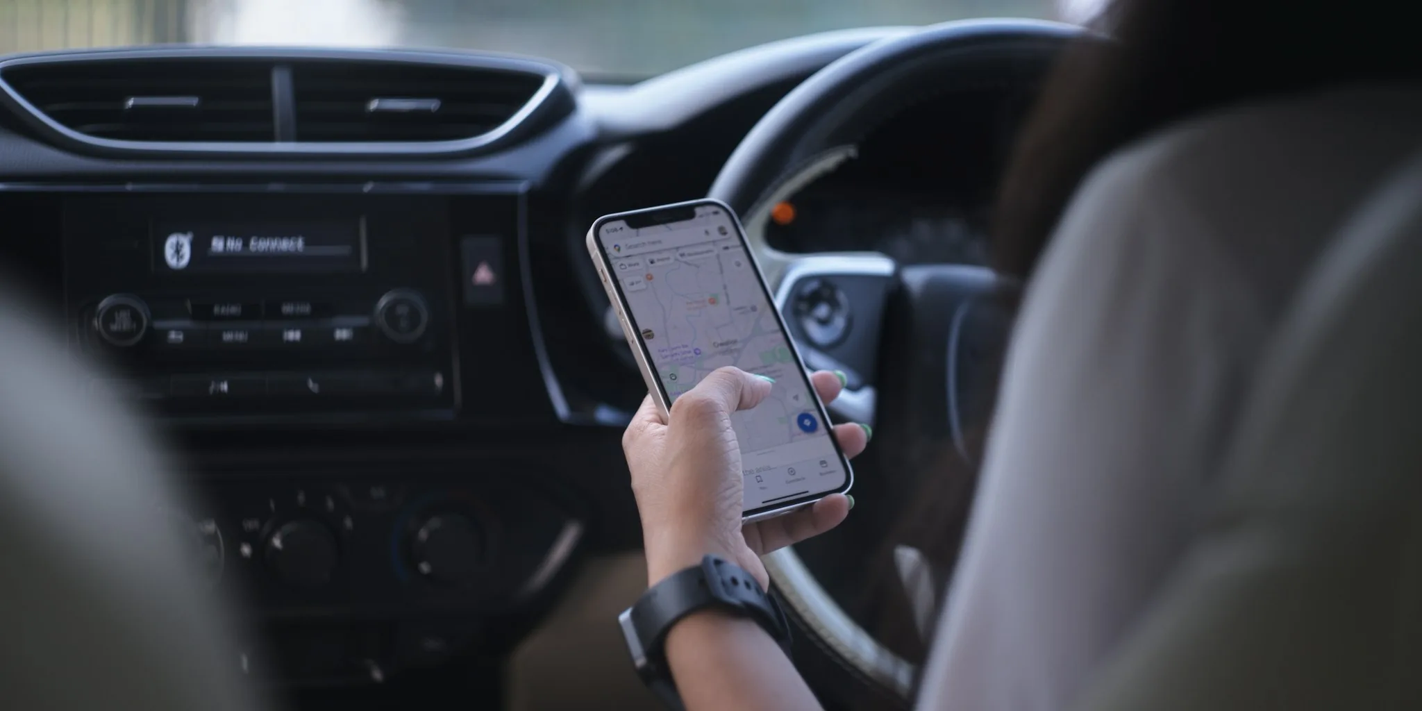 passenger using phone in car