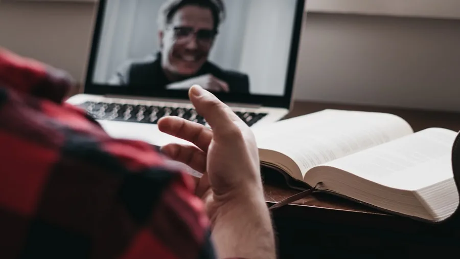 Person adjusting camera focus during video conference setup with professional lighting