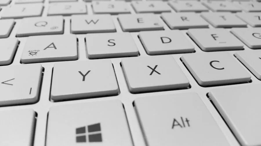 Person adjusting keyboard settings on computer screen during gaming setup customization