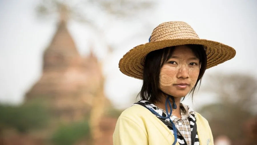 Person adjusting smart glasses by touching the temple while wearing them outdoors