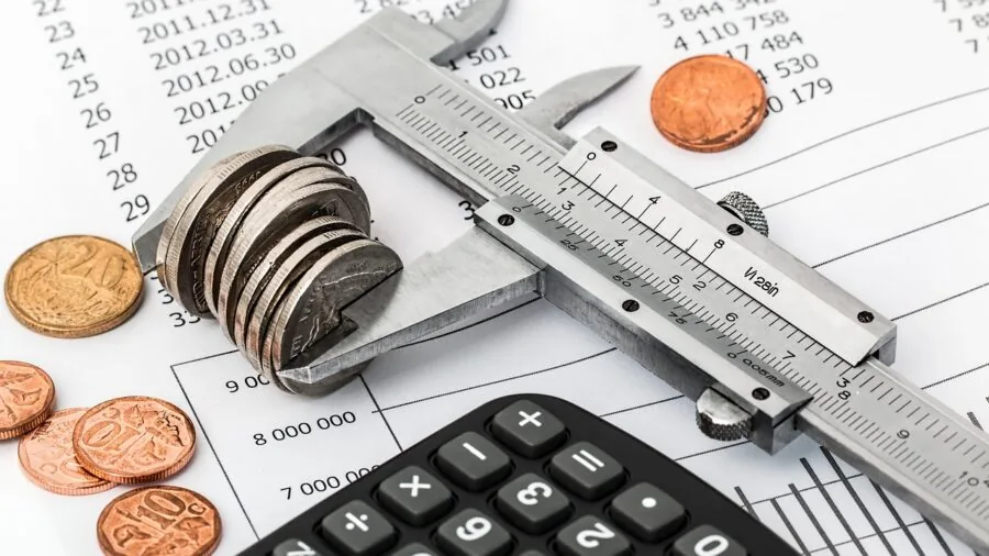 Person analyzing printer expenses and calculating long-term costs at home desk