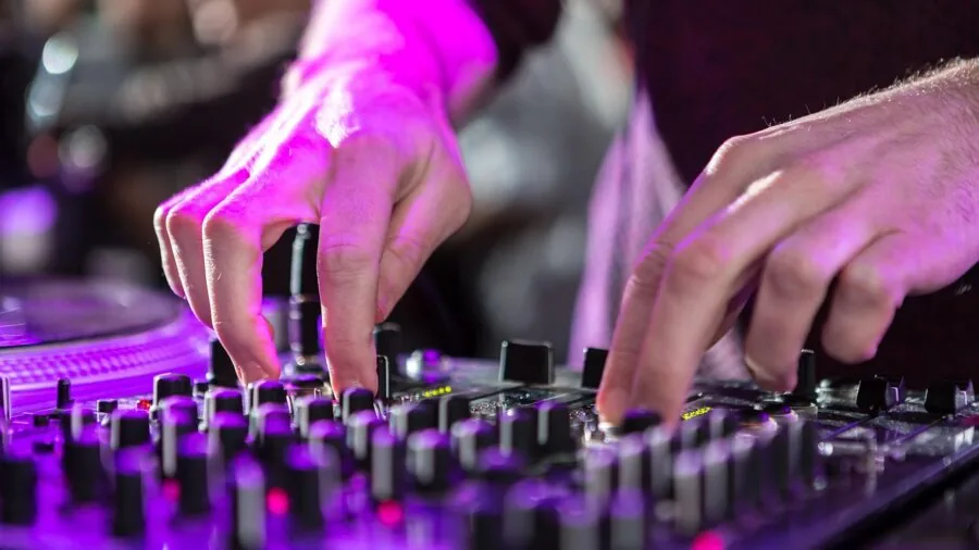 Person carefully inspecting audio equipment components for quality assessment and durability evaluation