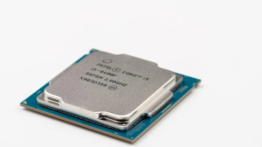 Person carefully installing CPU cooler on motherboard socket during PC build assembly