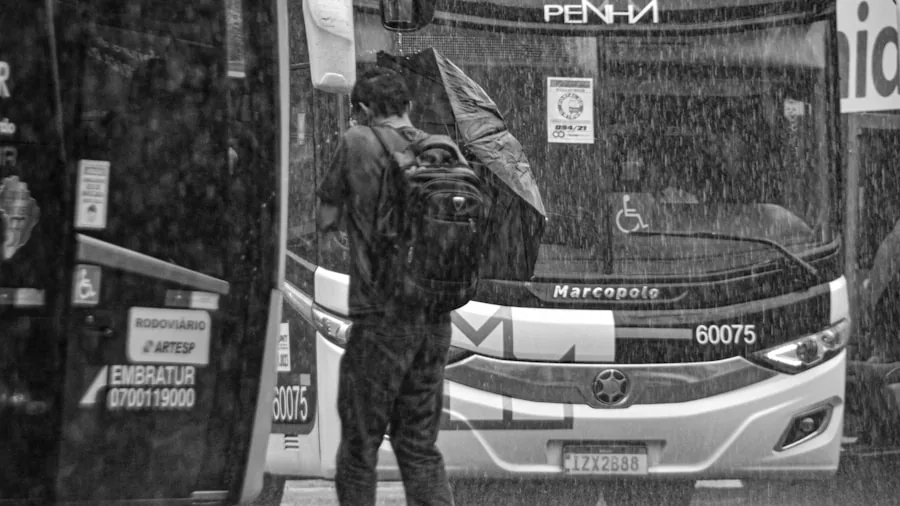 Person carrying durable travel bag in rainy weather outdoors