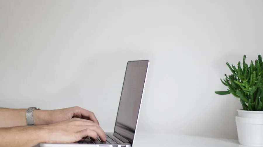 Person charging a wireless device with a power bank or charging cable in everyday setting