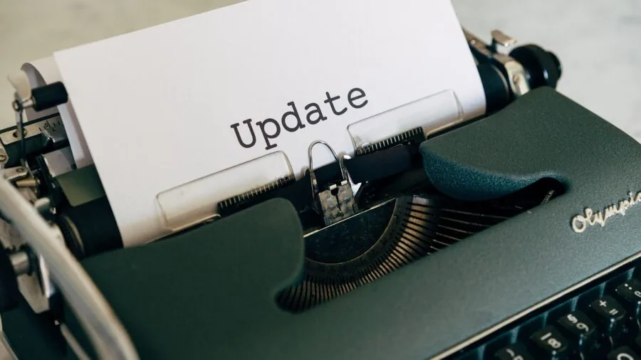 Person checking device software updates on tablet while sitting comfortably at home