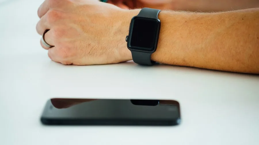 person checking phone with smartwatch