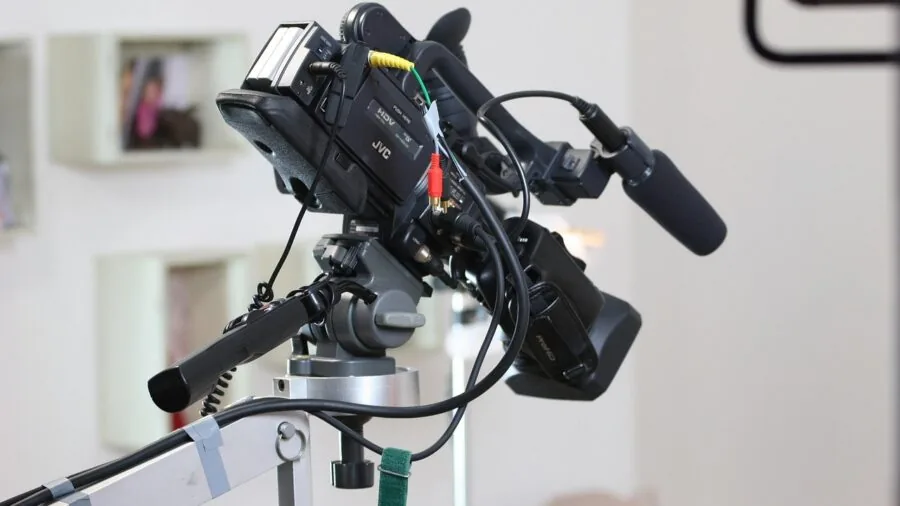 Person checking vintage camera battery and film pack before photography session