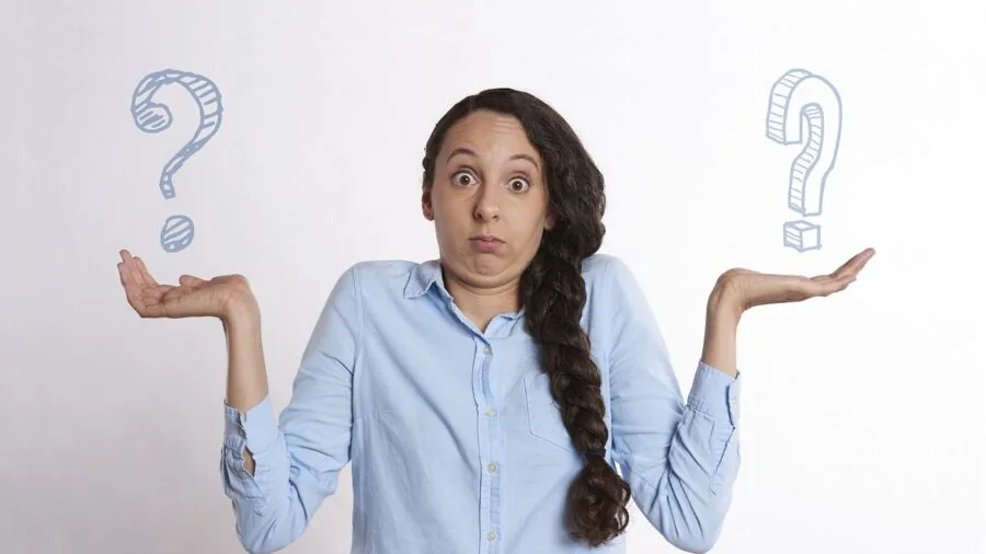 Person comparing options while shopping, analyzing choices between affordable and premium products