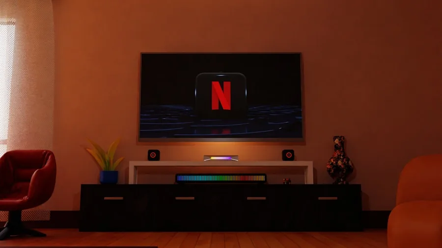 Person connecting cables to home theater equipment in a modern living room during evening