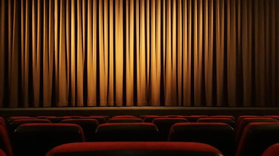 Person enjoying crystal clear 4K video on a large home theater television in a modern living room