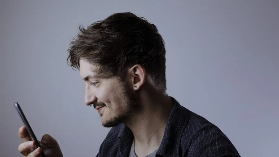 Person enjoying handheld gaming console in casual lifestyle setting