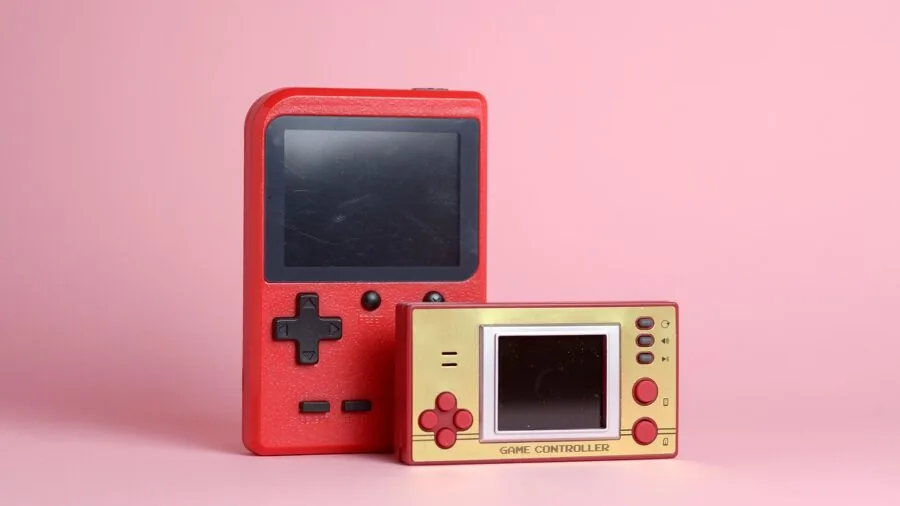 Person enjoying handheld gaming console outdoors in natural daylight, focused on screen visibility and comfort