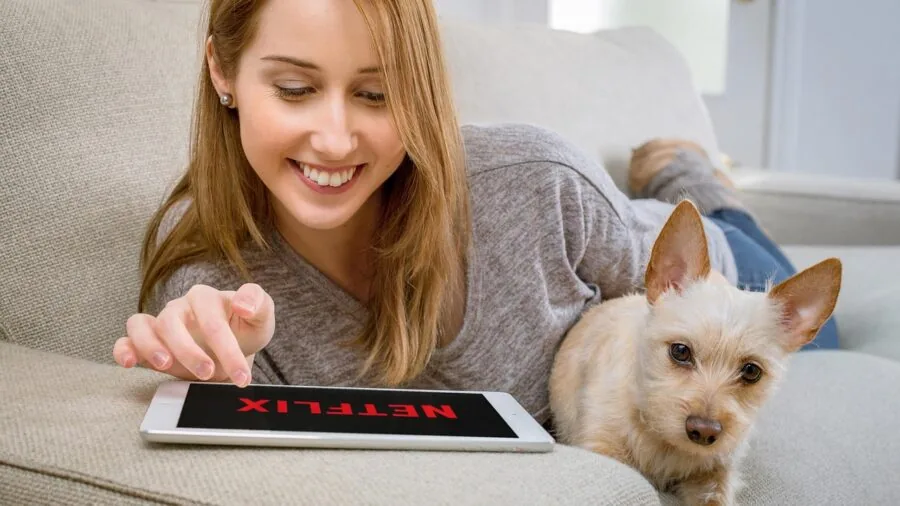 Person enjoying HD video streaming on laptop at home with reliable internet connection