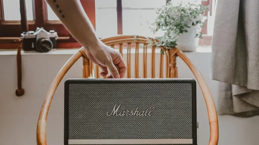 Person enjoying music from a smart speaker in a modern living room setting