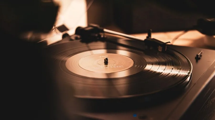 Person enjoying music in a cozy living room with quality speakers and sound system setup