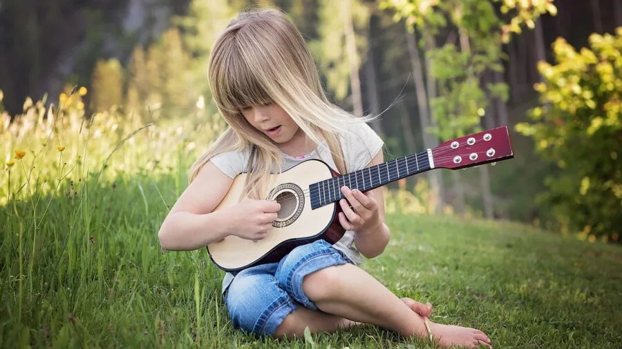 Person enjoying music outdoors in natural environment, demonstrating open audio experience