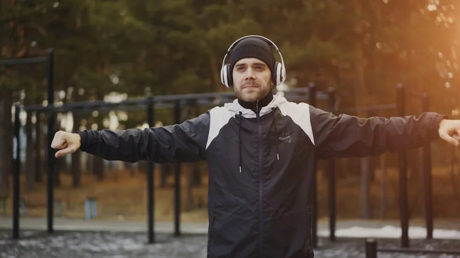 Person enjoying music outdoors with headphones in natural setting