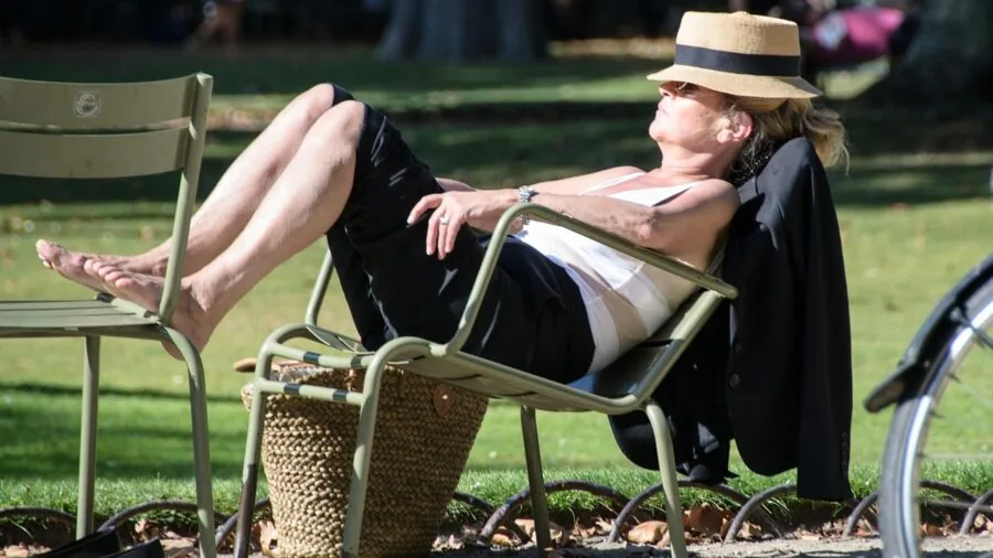 Person enjoying music with comfortable headphones during a relaxed moment outdoors