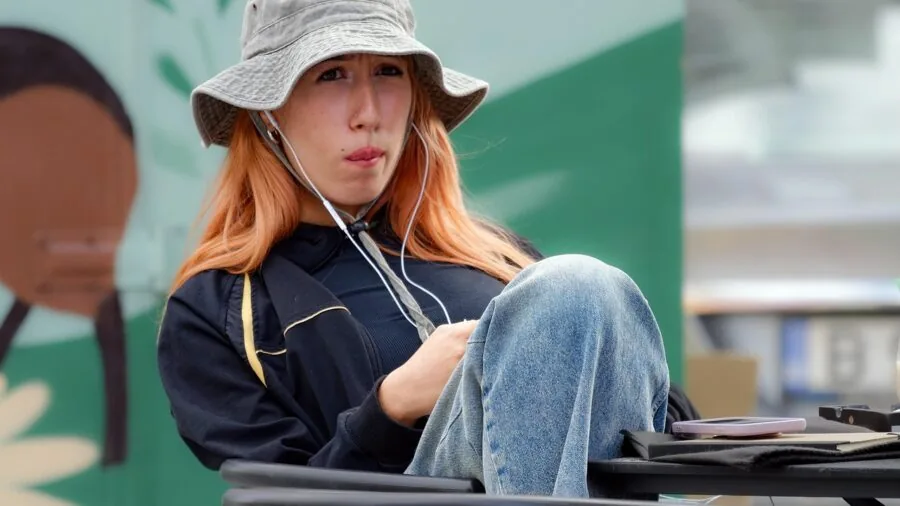 Person enjoying music with earbuds in a natural outdoor setting