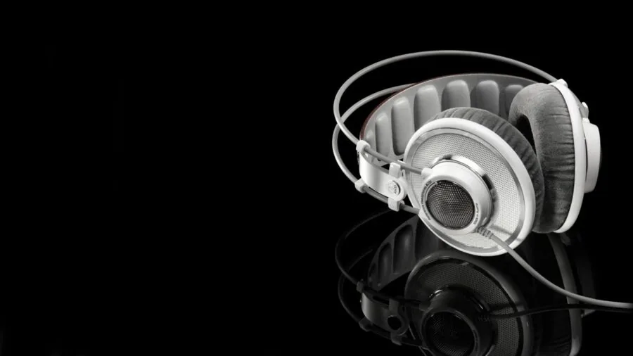 Person enjoying music with headphones in a focused, attentive moment during listening session