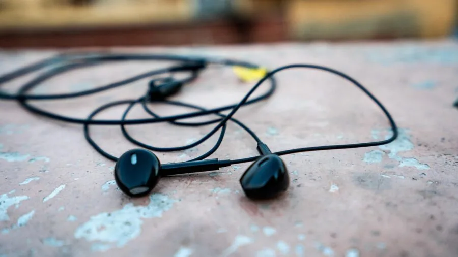 Person enjoying music with wired headphones in a casual, real-life setting