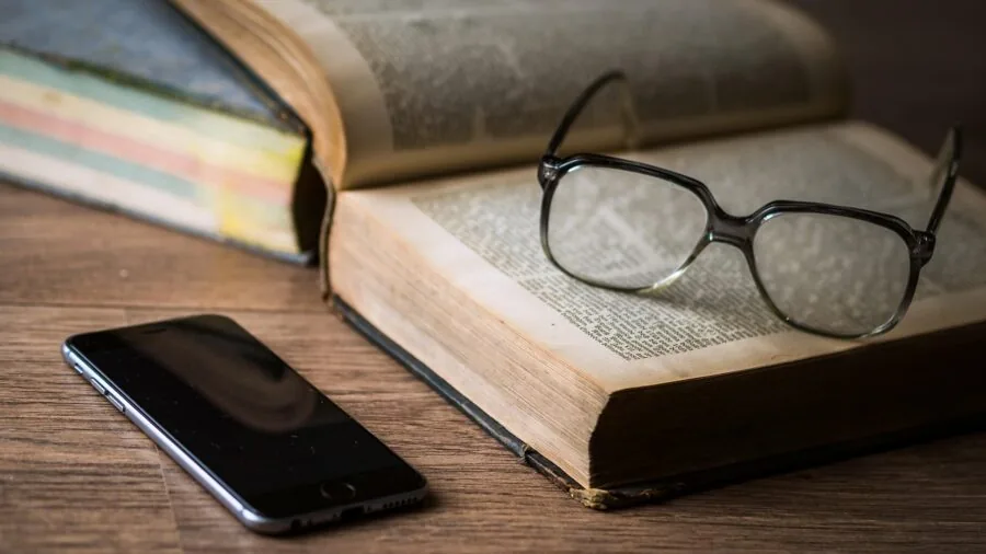 Person enjoying reading on an affordable e-reader device in a comfortable everyday setting