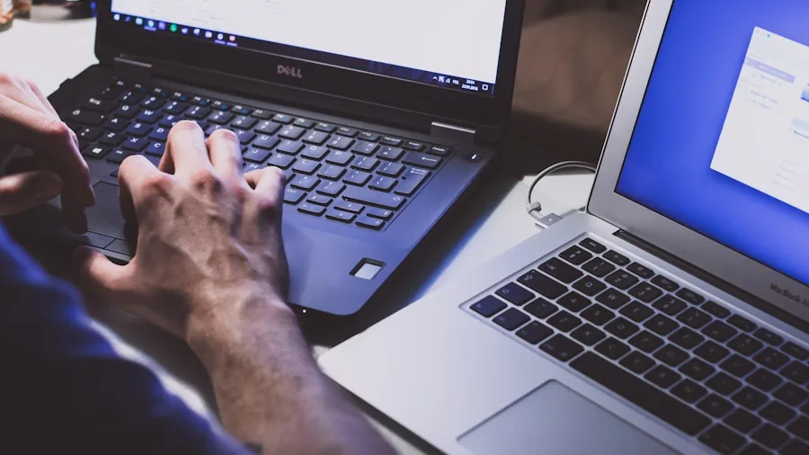 Person examining laptop build quality and hinge durability during hands-on testing