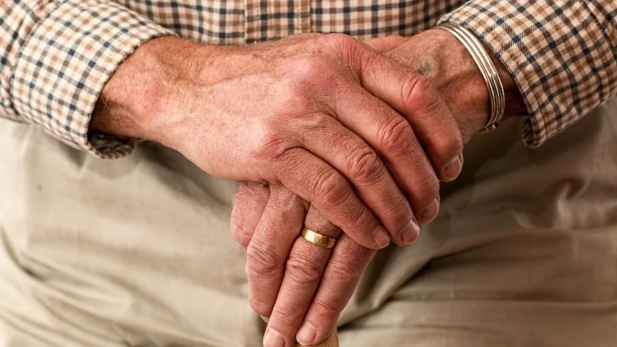 Person examining ring fit on finger to ensure proper sizing and comfort