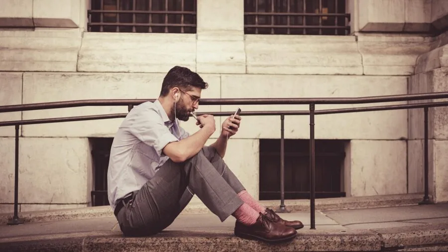 Person examining smartphone performance specifications while making a purchasing decision indoors