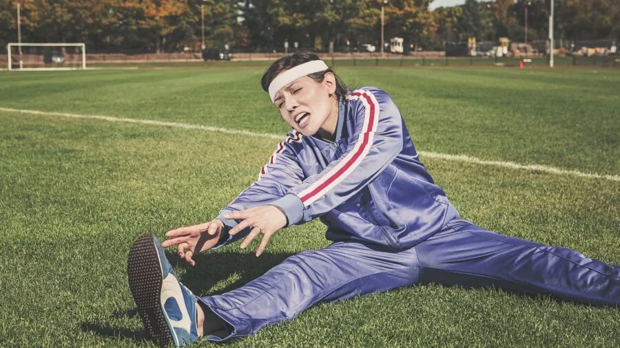 Person exercising intensely with sweat visible during outdoor workout training session