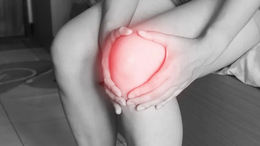 Person experiencing discomfort while exercising intensely, showing signs of fatigue and heat