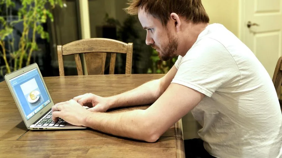 Person focused on computer work at desk, representing technology decision-making and research