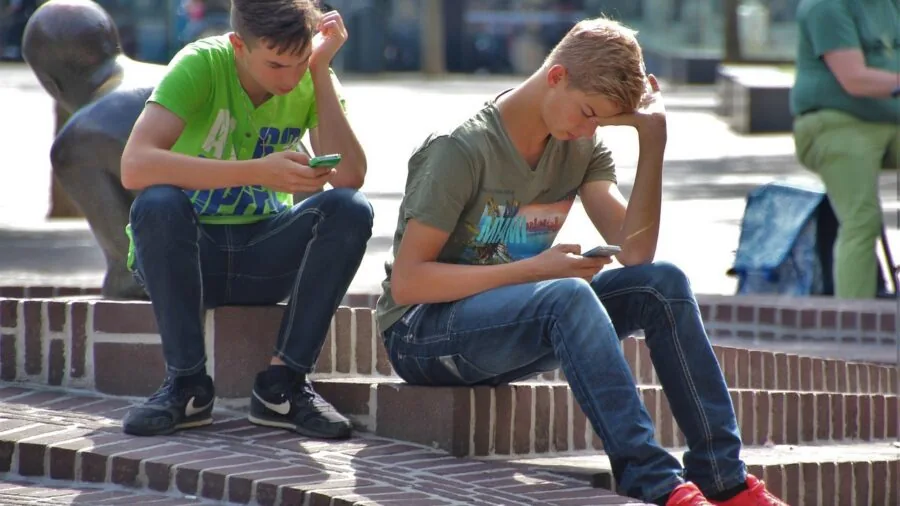 Person focused on playing an intense mobile game on smartphone, showing gaming engagement and concentration