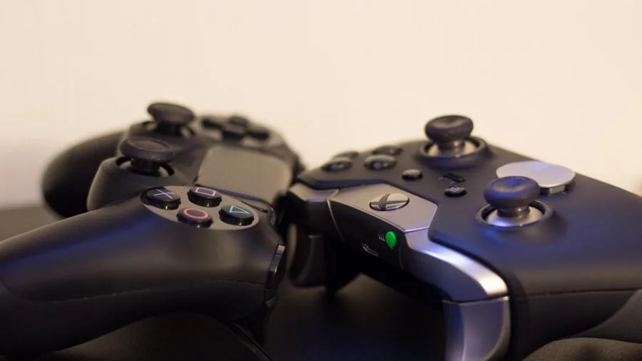 Person gaming on different platforms, switching between devices for cross-platform gaming setup