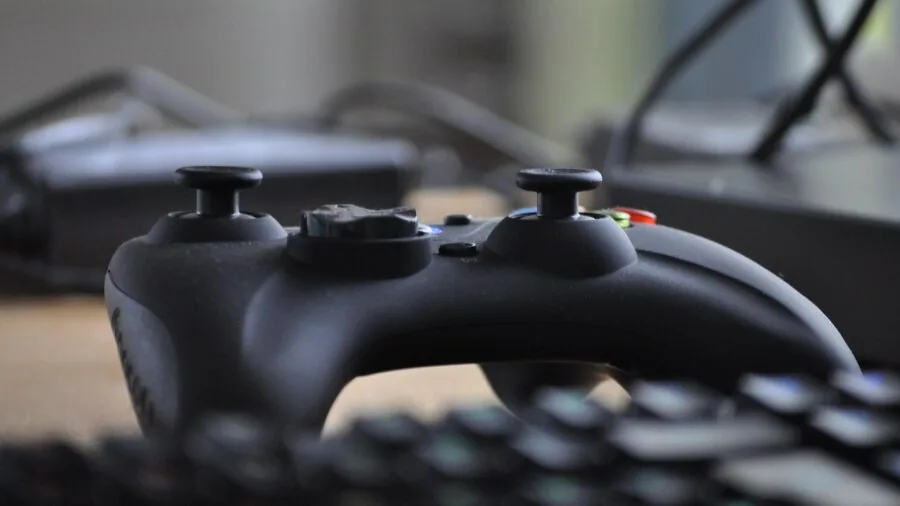 Person gaming with controller focused on responsive gameplay and input precision