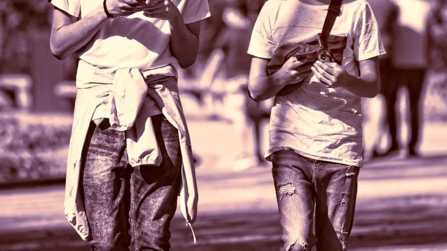 Person glancing at smartphone screen to check battery percentage during daily use