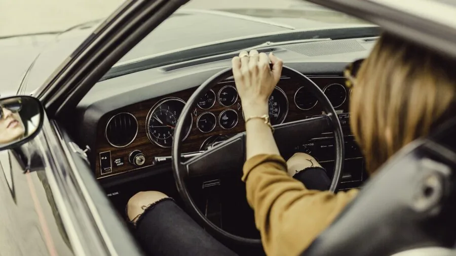 Person gripping steering wheel during intense racing simulation gameplay session