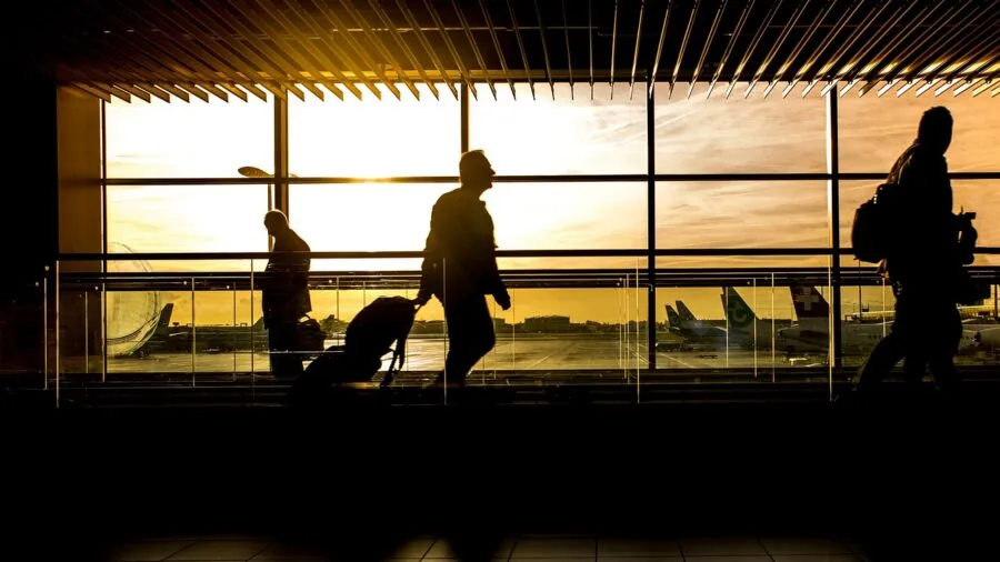 Person having a phone conversation in an airport terminal during travel