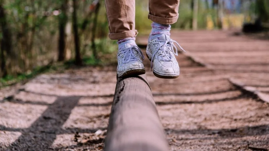 Person hiking outdoors on sunny day, enjoying extended outdoor adventure with wireless audio