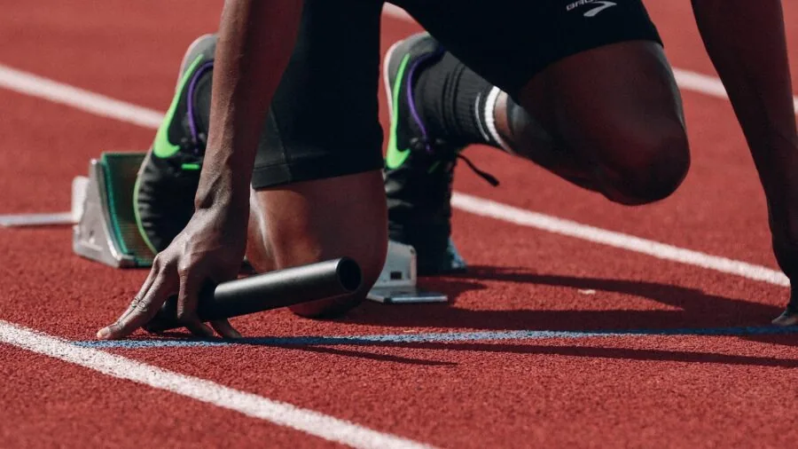 Person holding camera recording outdoor sports event with steady hand position