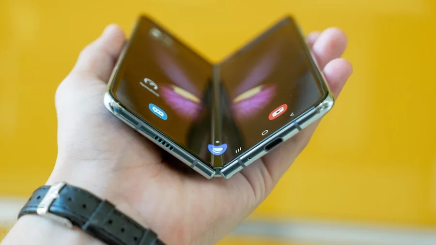 person holding compact folded phone