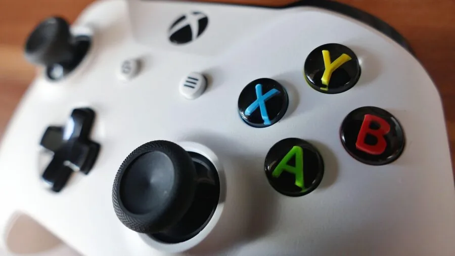 Person holding handheld gaming device while playing multiplayer online game in casual home setting
