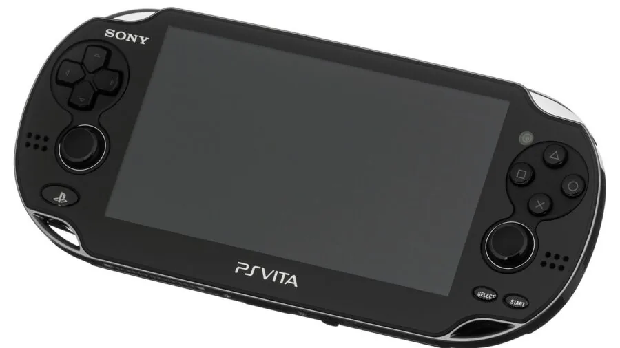 Person holding handheld gaming device while relaxing outdoors in natural daylight