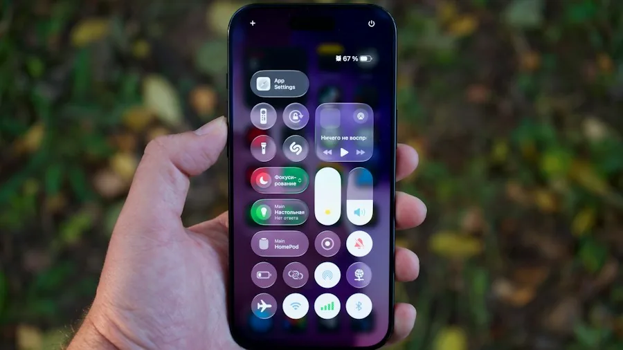 person holding iPhone checking settings menu